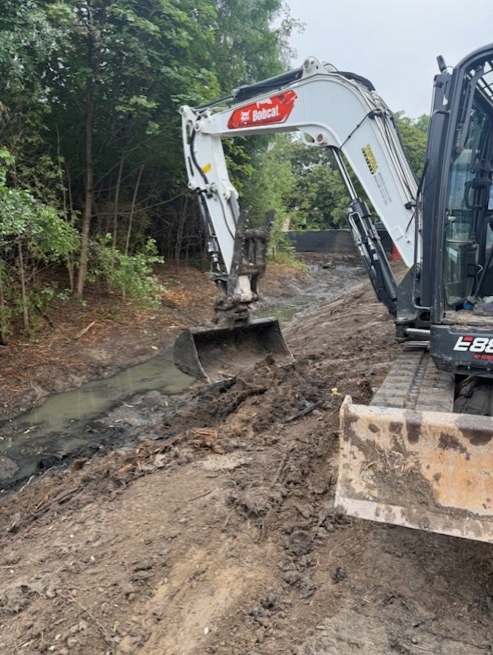 Excavator removing accumulated sediment from the Evergreen Estate watercourse