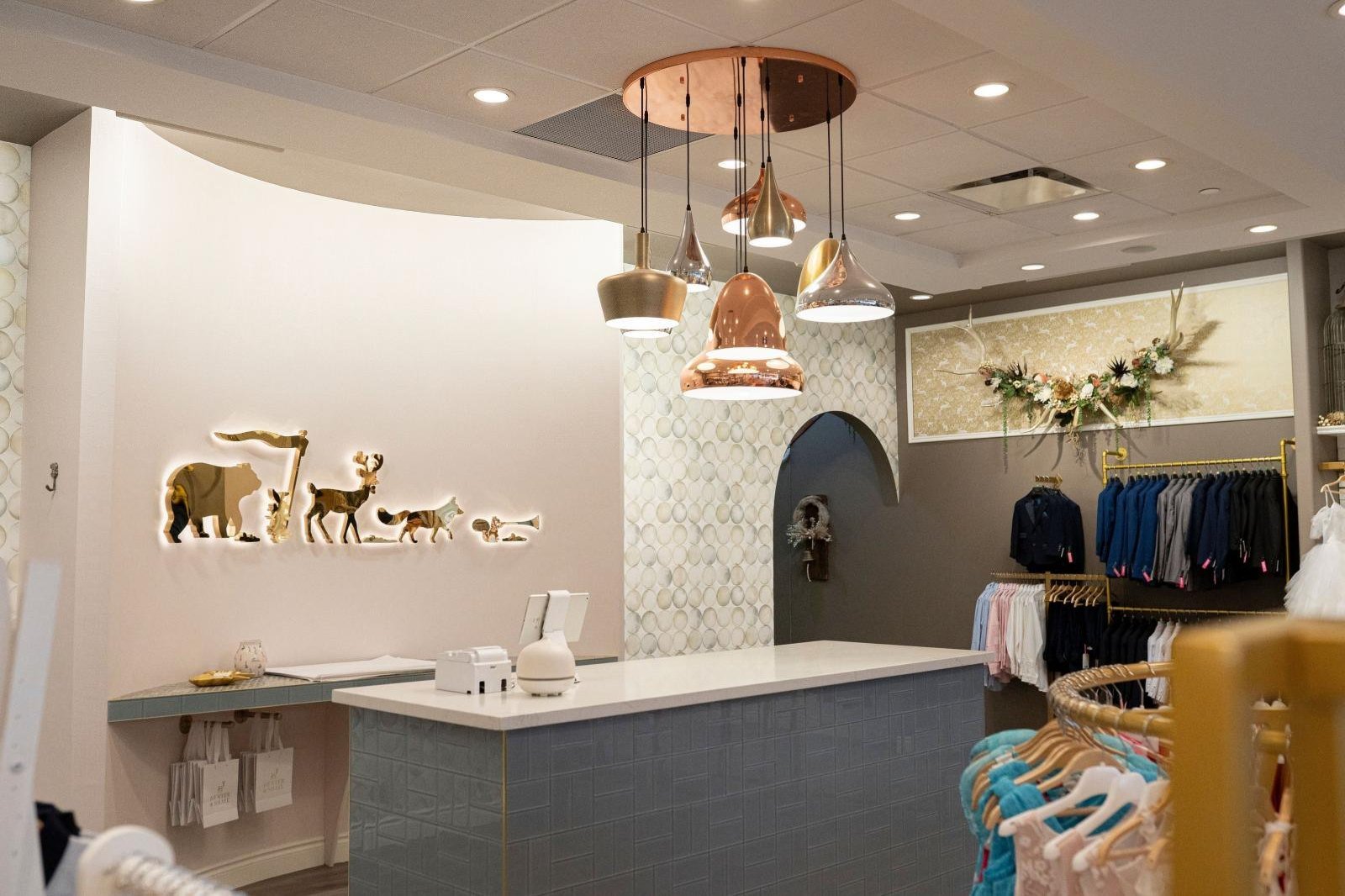 Hunter & Shaye boutique interior with custom millwork and pendant lighting